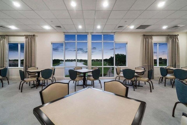 dining area featuring light carpet