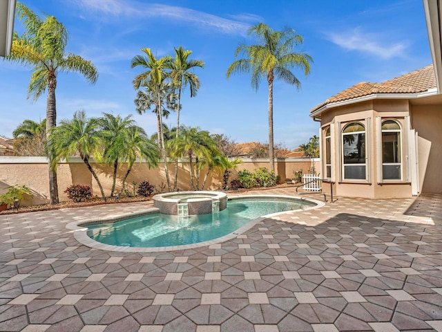 view of pool with an in ground hot tub and a patio