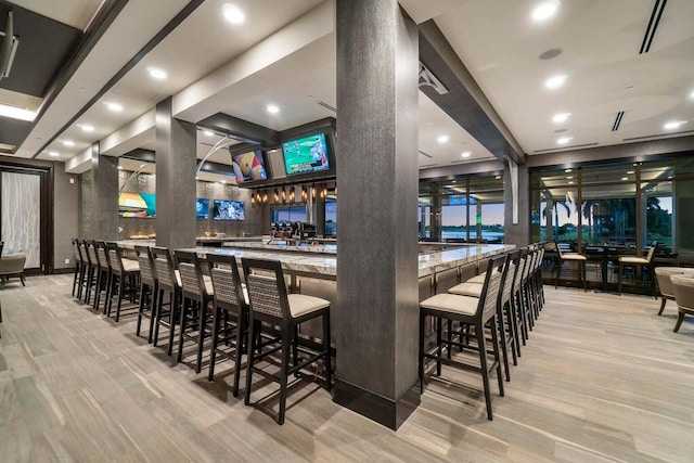 bar featuring light hardwood / wood-style flooring