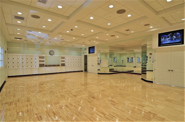 workout area featuring coffered ceiling