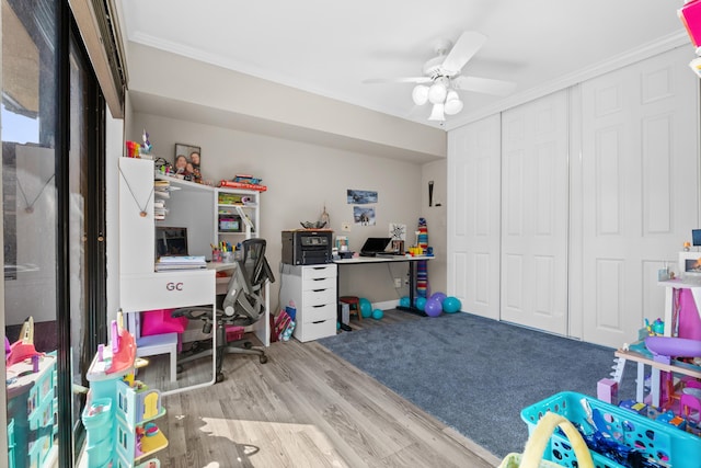 playroom featuring light hardwood / wood-style floors, ceiling fan, and ornamental molding