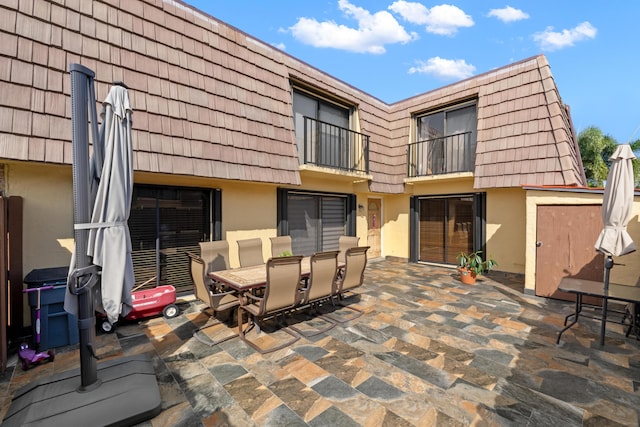 view of patio featuring a balcony