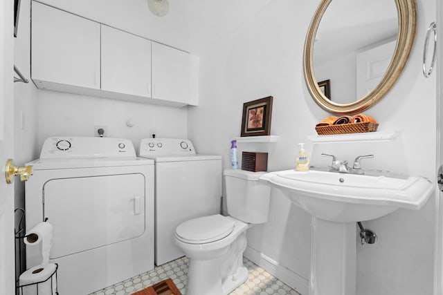 bathroom with toilet and washing machine and clothes dryer