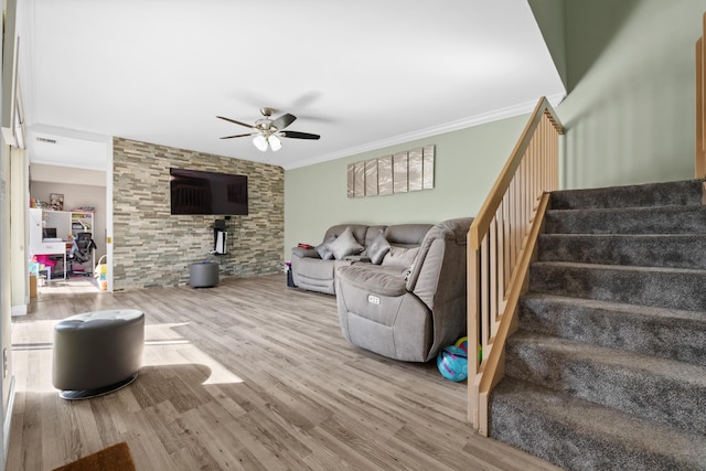 living room featuring hardwood / wood-style flooring, ceiling fan, and crown molding