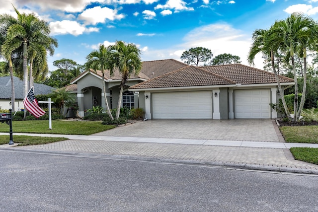 view of front of house with a garage and a front lawn