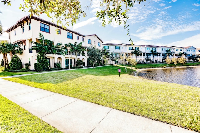 view of community with a water view and a yard