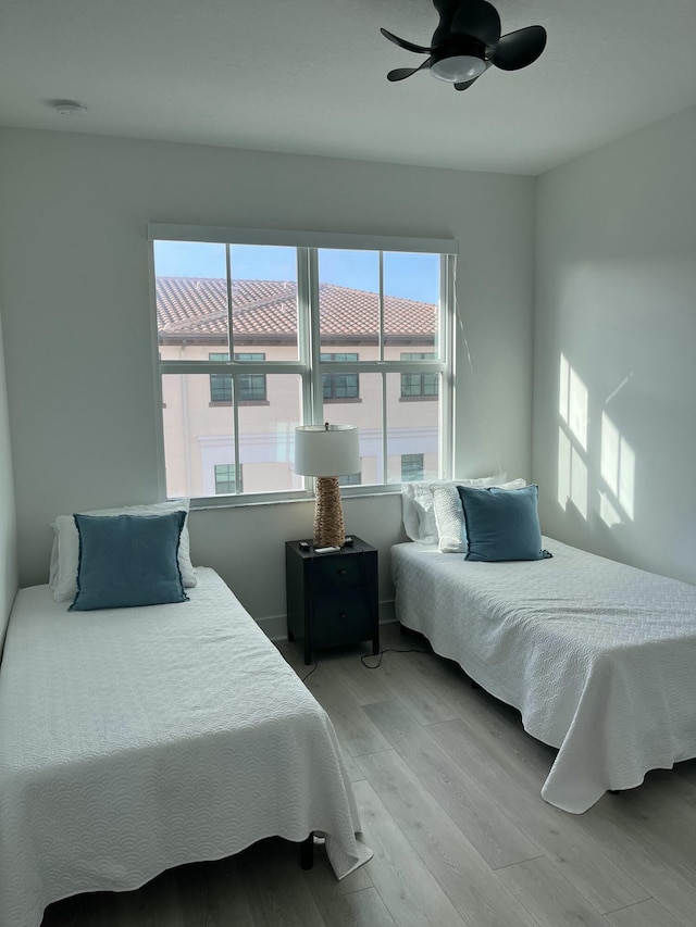 bedroom with ceiling fan and light hardwood / wood-style floors