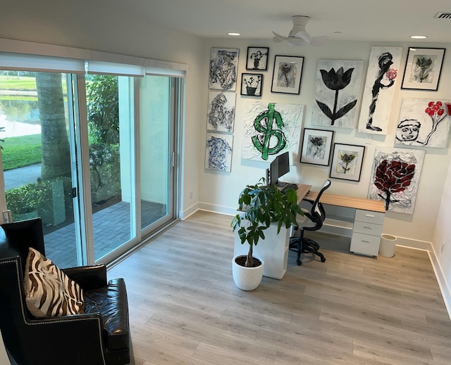 home office with ceiling fan and light wood-type flooring