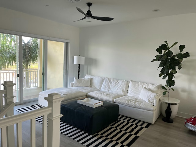 living room with wood-type flooring and ceiling fan