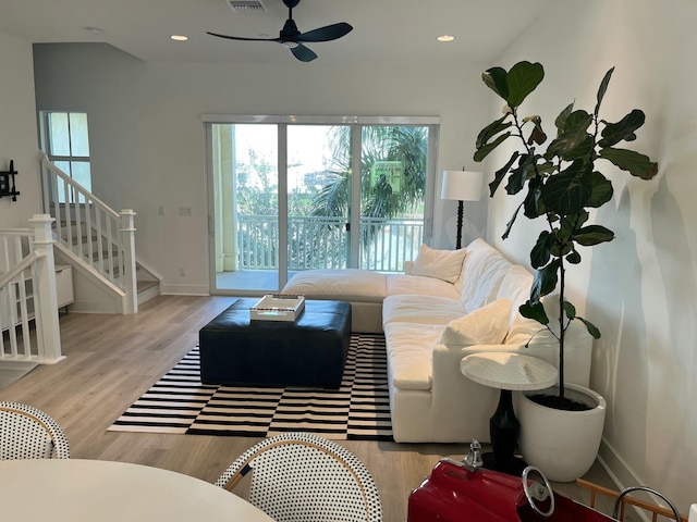 living room with ceiling fan and light wood-type flooring