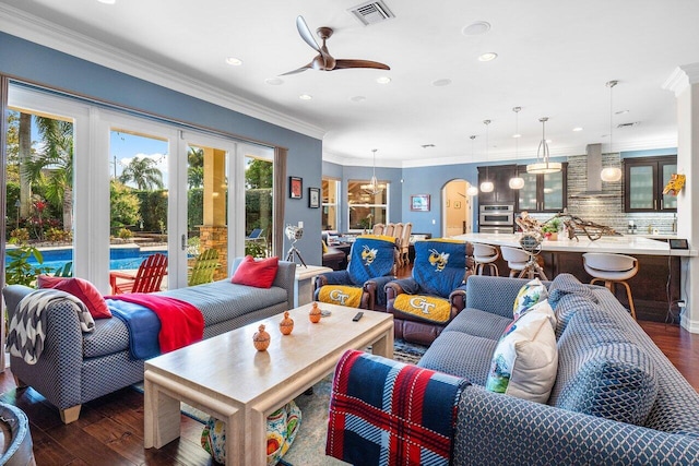 living room featuring ceiling fan, dark hardwood / wood-style flooring, and crown molding