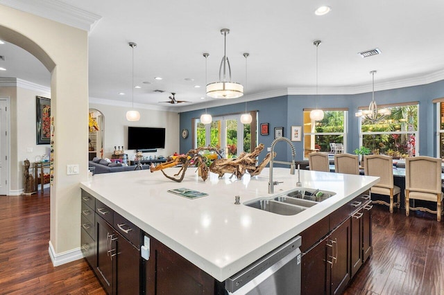 kitchen with dishwasher, sink, an island with sink, decorative light fixtures, and ceiling fan with notable chandelier