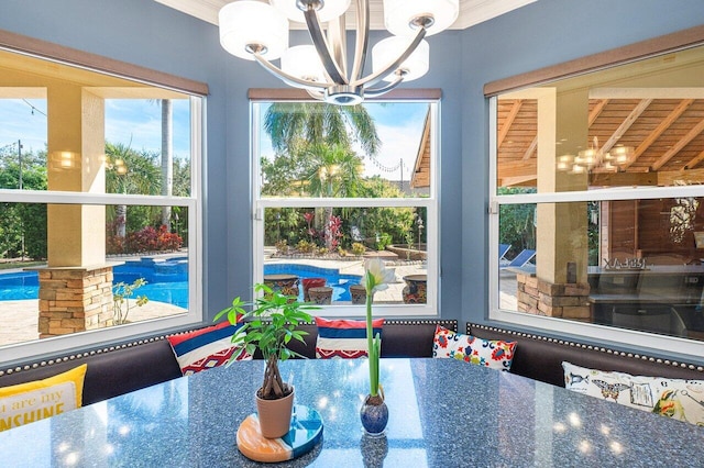 dining space featuring ornamental molding and an inviting chandelier