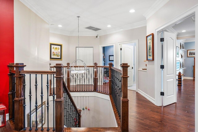 staircase featuring wood-type flooring and ornamental molding