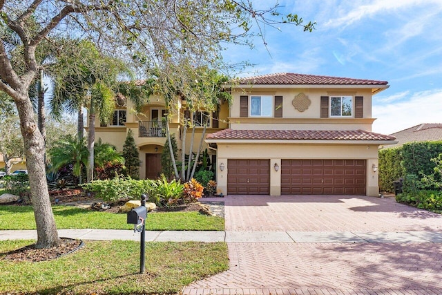 mediterranean / spanish house with a balcony and a garage