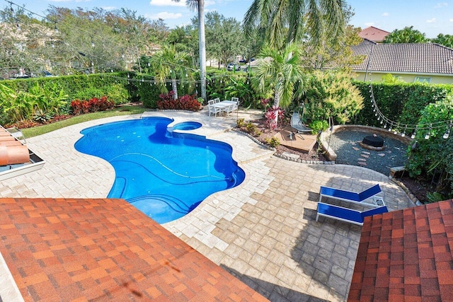 view of swimming pool with an in ground hot tub and a patio