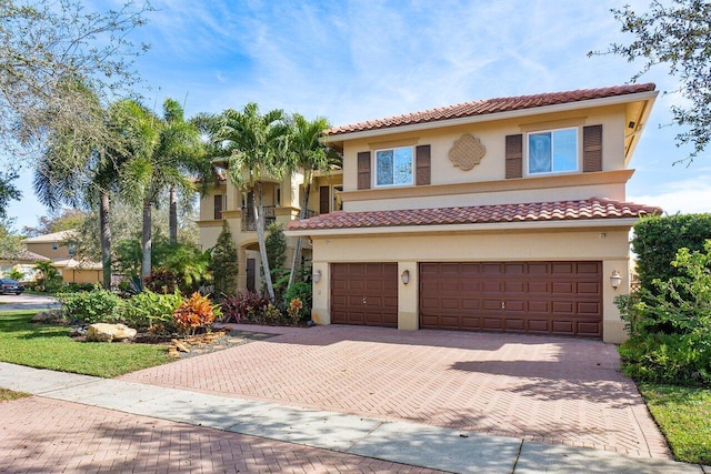 mediterranean / spanish-style house with a garage