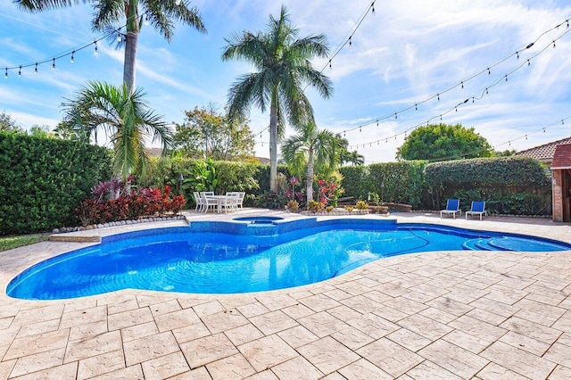 view of pool featuring an in ground hot tub and a patio area