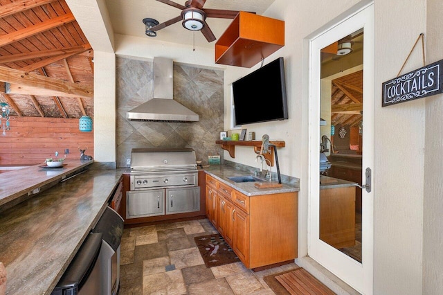 kitchen featuring wood ceiling, sink, wall chimney range hood, beamed ceiling, and wood walls