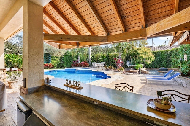 view of swimming pool featuring a gazebo, a patio area, and exterior bar