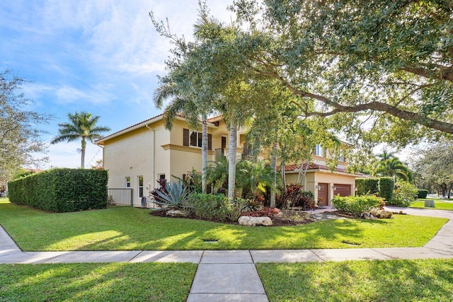 view of home's exterior with a lawn and a garage