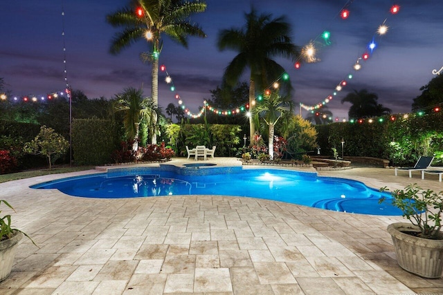 view of pool featuring an in ground hot tub and a patio area