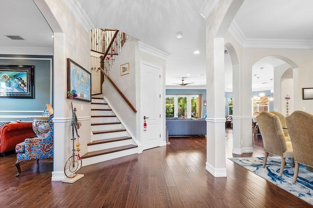 entrance foyer featuring dark wood-type flooring, ceiling fan, and ornamental molding