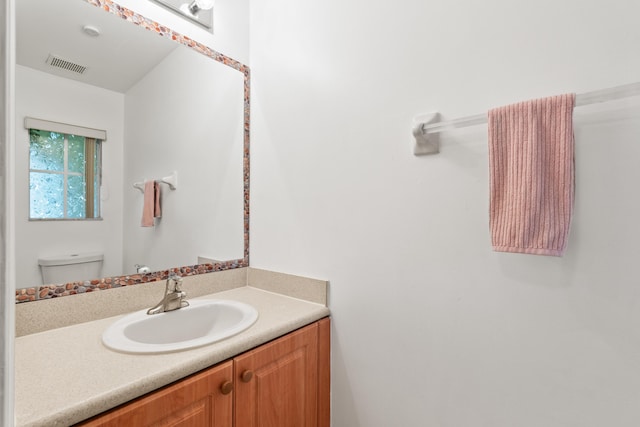 bathroom with toilet and vanity