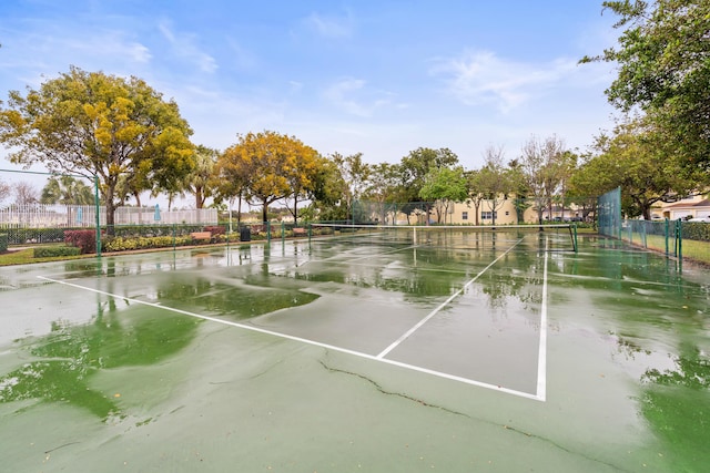 view of property's community with tennis court