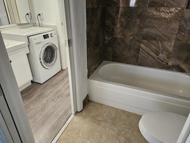 bathroom with vanity, washer / clothes dryer, and toilet