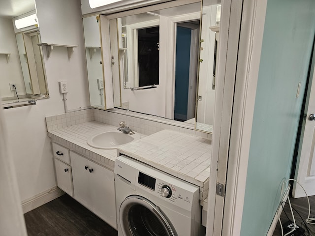 bathroom featuring hardwood / wood-style flooring, vanity, and washer / clothes dryer