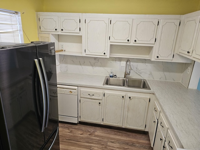 kitchen with white cabinetry, dishwasher, sink, black refrigerator with ice dispenser, and dark hardwood / wood-style flooring