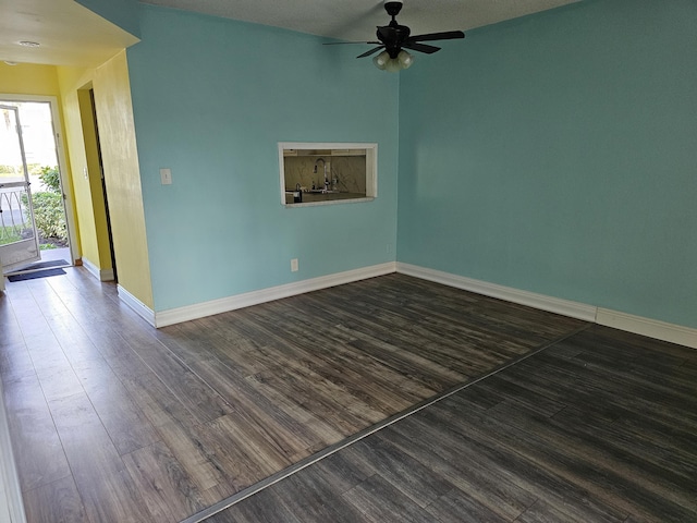 unfurnished room with a textured ceiling, dark hardwood / wood-style flooring, and ceiling fan