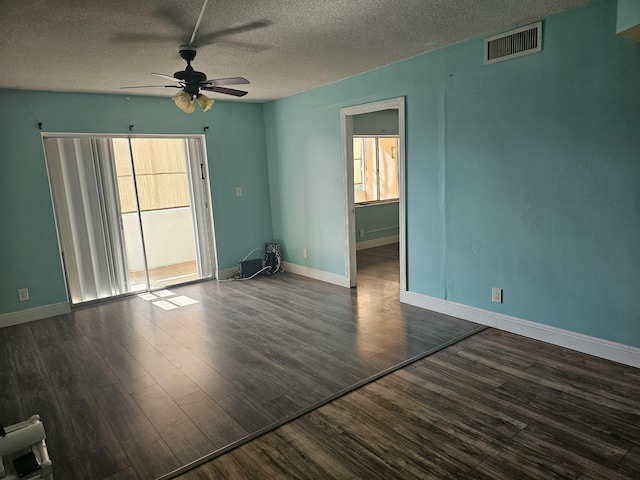 spare room featuring a textured ceiling, ceiling fan, and dark wood-type flooring