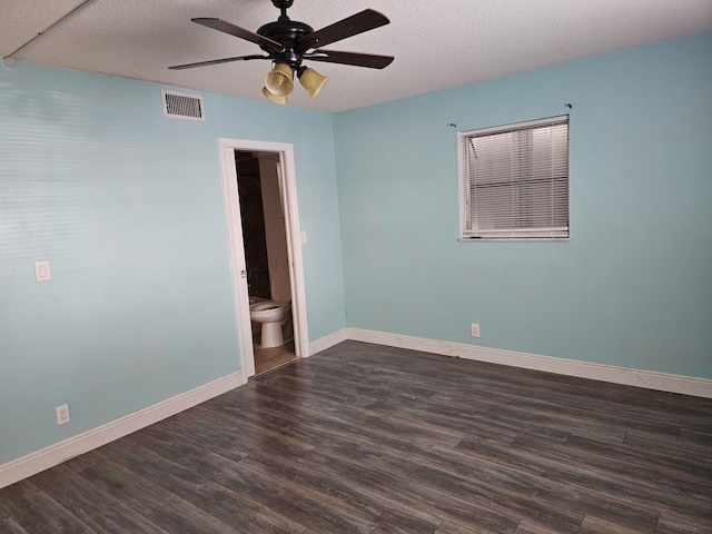 empty room featuring ceiling fan, dark hardwood / wood-style floors, and a textured ceiling