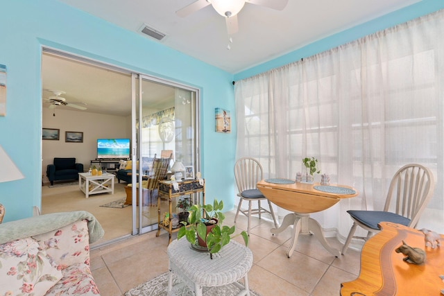 interior space featuring light tile patterned floors and ceiling fan