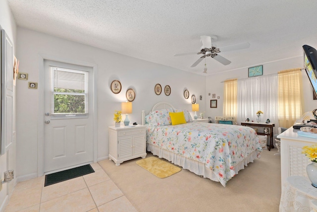 tiled bedroom with ceiling fan and a textured ceiling