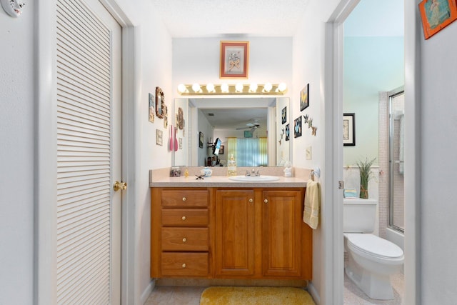 full bathroom with vanity, toilet, shower / bath combination with glass door, and a textured ceiling