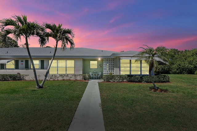 ranch-style house with a yard