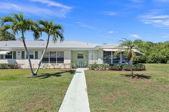 ranch-style home with a front lawn