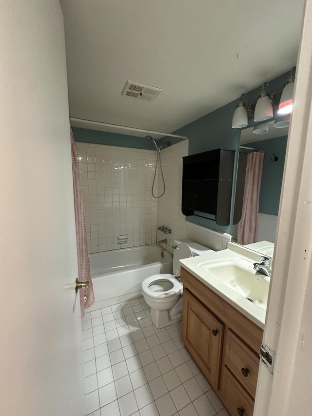 full bathroom with toilet, shower / bath combo, vanity, and tile patterned floors