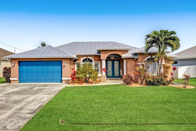 ranch-style house featuring a front lawn, a garage, and french doors