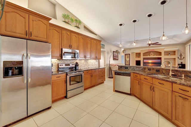 kitchen with pendant lighting, appliances with stainless steel finishes, sink, vaulted ceiling, and ceiling fan