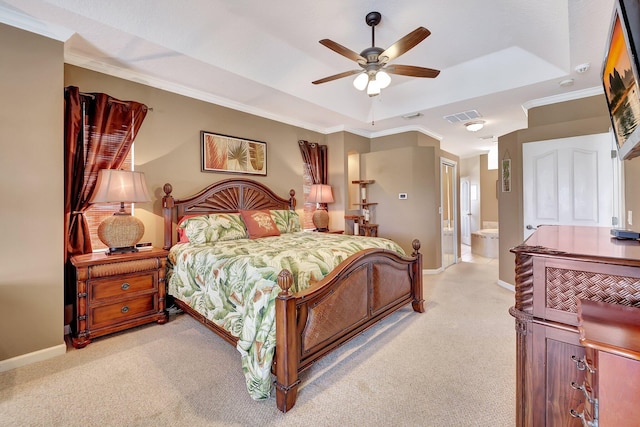 bedroom featuring a raised ceiling, light colored carpet, ceiling fan, and connected bathroom