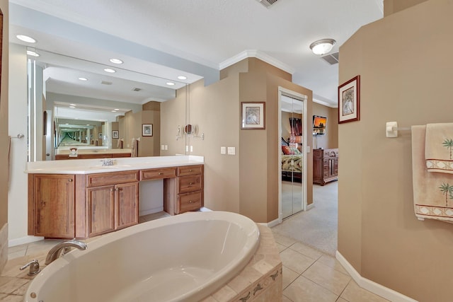 bathroom with vanity, tile patterned floors, ornamental molding, and tiled tub