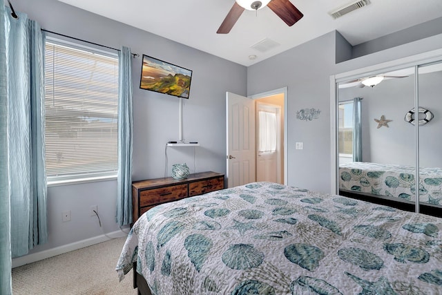 carpeted bedroom with ceiling fan and a closet