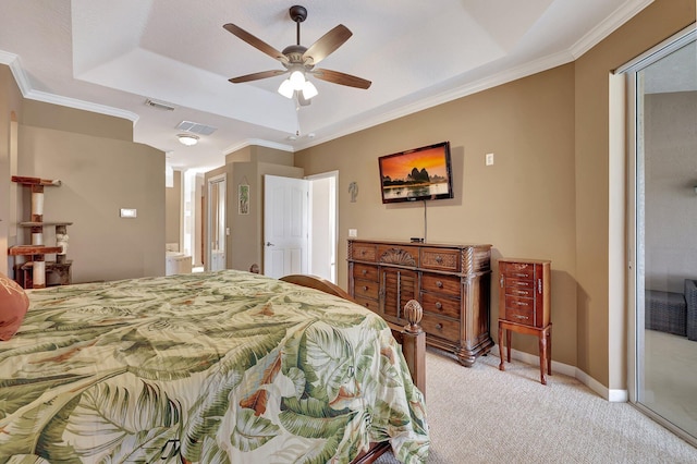 carpeted bedroom with ceiling fan, a tray ceiling, and ornamental molding