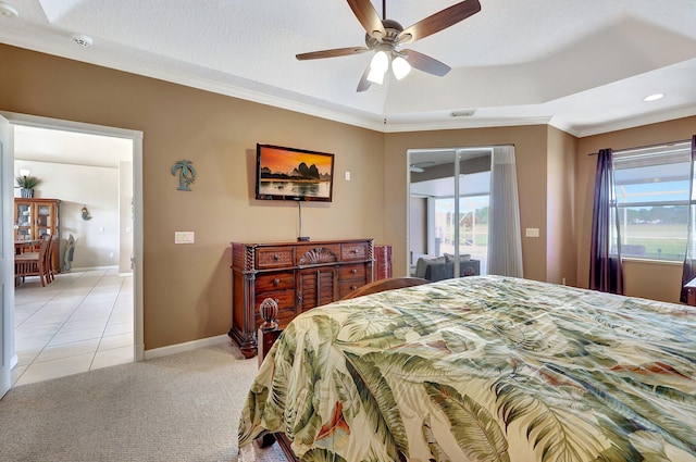 carpeted bedroom with ceiling fan, crown molding, a tray ceiling, and access to outside