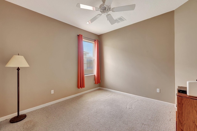 spare room with carpet floors and ceiling fan