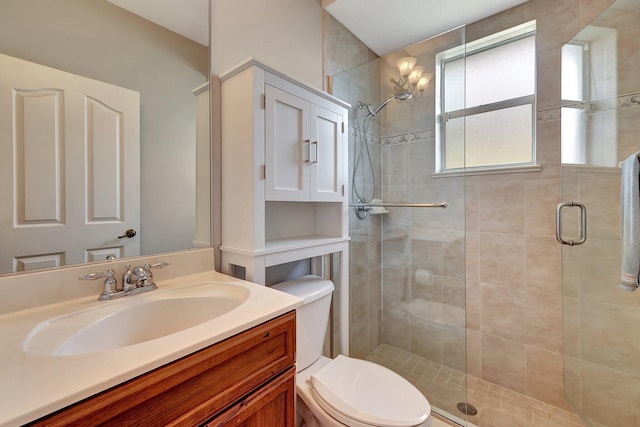 bathroom with toilet, a shower with shower door, and vanity